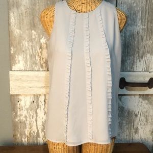 Sleeveless shirt with cute ruffles.